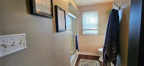 a bathroom with a sink a toilet and shower