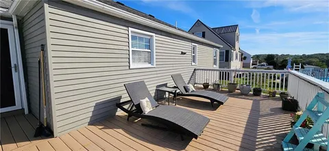 a view of balcony with furniture and wooden deck