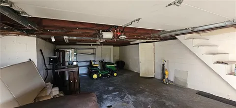 a view of a house with a yard and potted plants