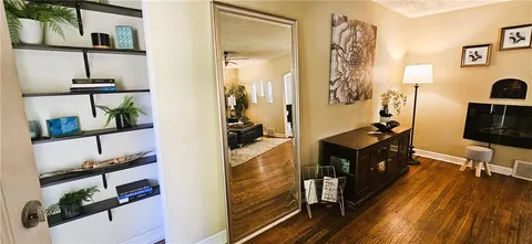 a view of a walk in closet with clothes and shoes