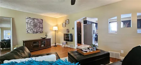 a living room with furniture and a flat screen tv