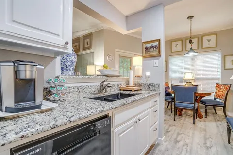a kitchen with stainless steel appliances granite countertop a stove and a sink
