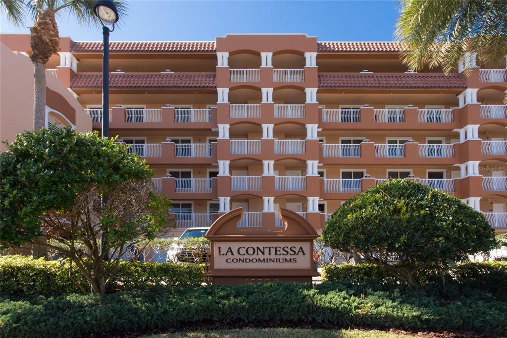 16326 Gulf Boulevard, Unit 307 Redington Beach, FL 33708 - Photo 2 of 43 a front view of a building with garden