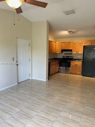 a view of kitchen and empty room