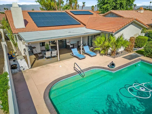 an outdoor sitting area with furniture and garden