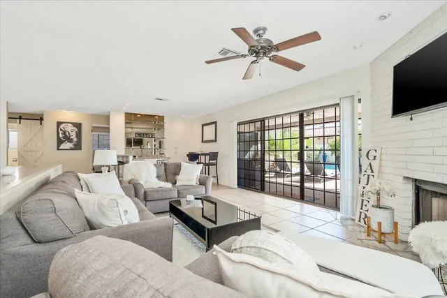 a living room with fireplace furniture and a flat screen tv