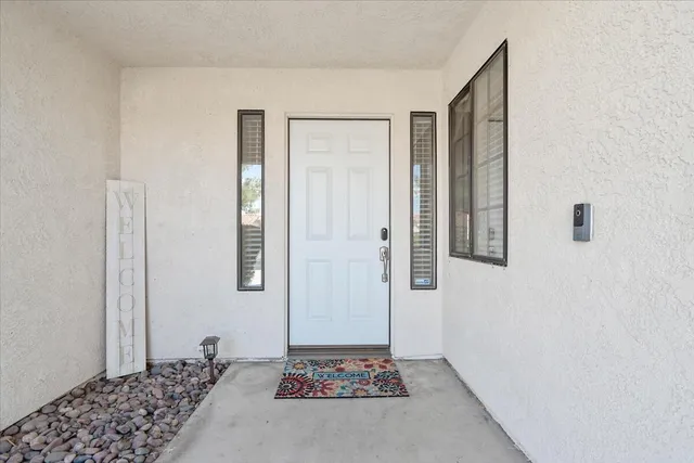 a view of a hallway with closet and wooden floor