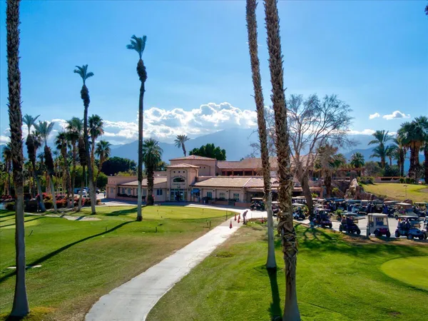 a view of a lake with a big yard and palm trees