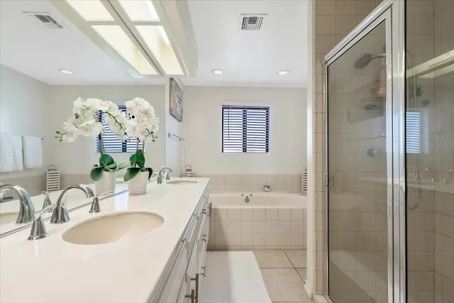 a bathroom with a tub sink double and mirror