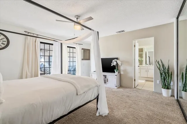 a bedroom with a bed closet and a window