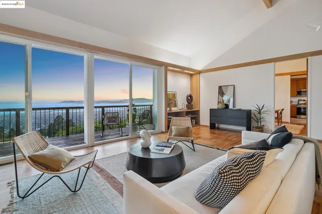 a living room with furniture and a floor to ceiling window