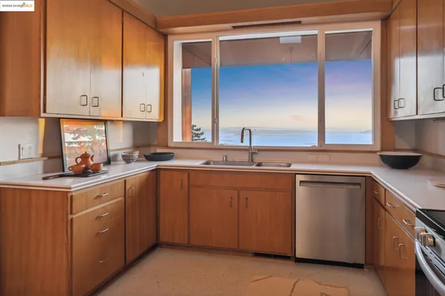a kitchen with a table chairs sink and cabinets