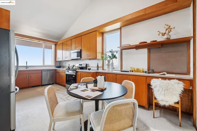a kitchen with sink refrigerator and cabinets