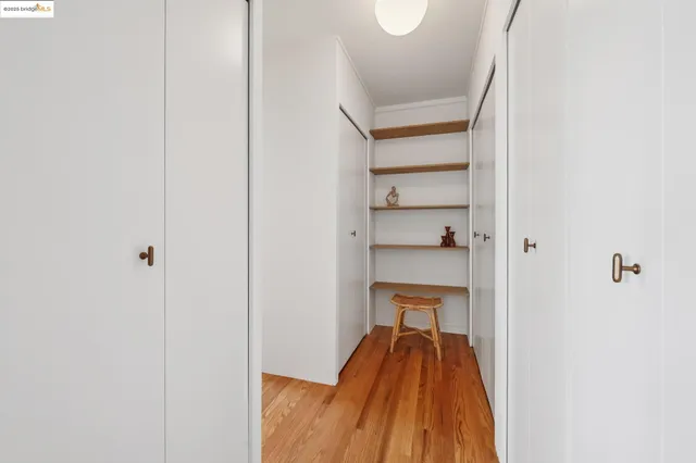 a spacious bedroom with two beds and painting on the wall