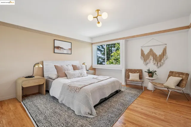 a bedroom with a bed and a painting on the wall