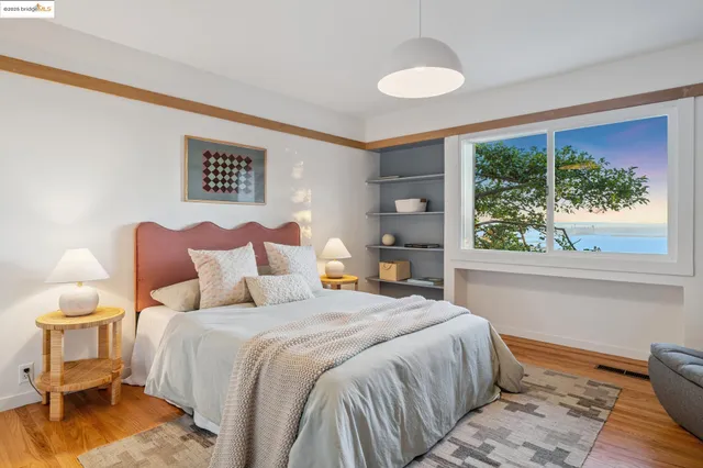 a bedroom with a large bed and a window