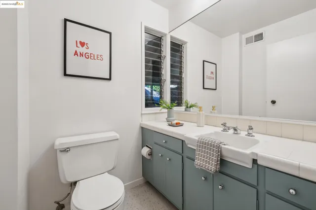 a bathroom with a toilet sink and mirror