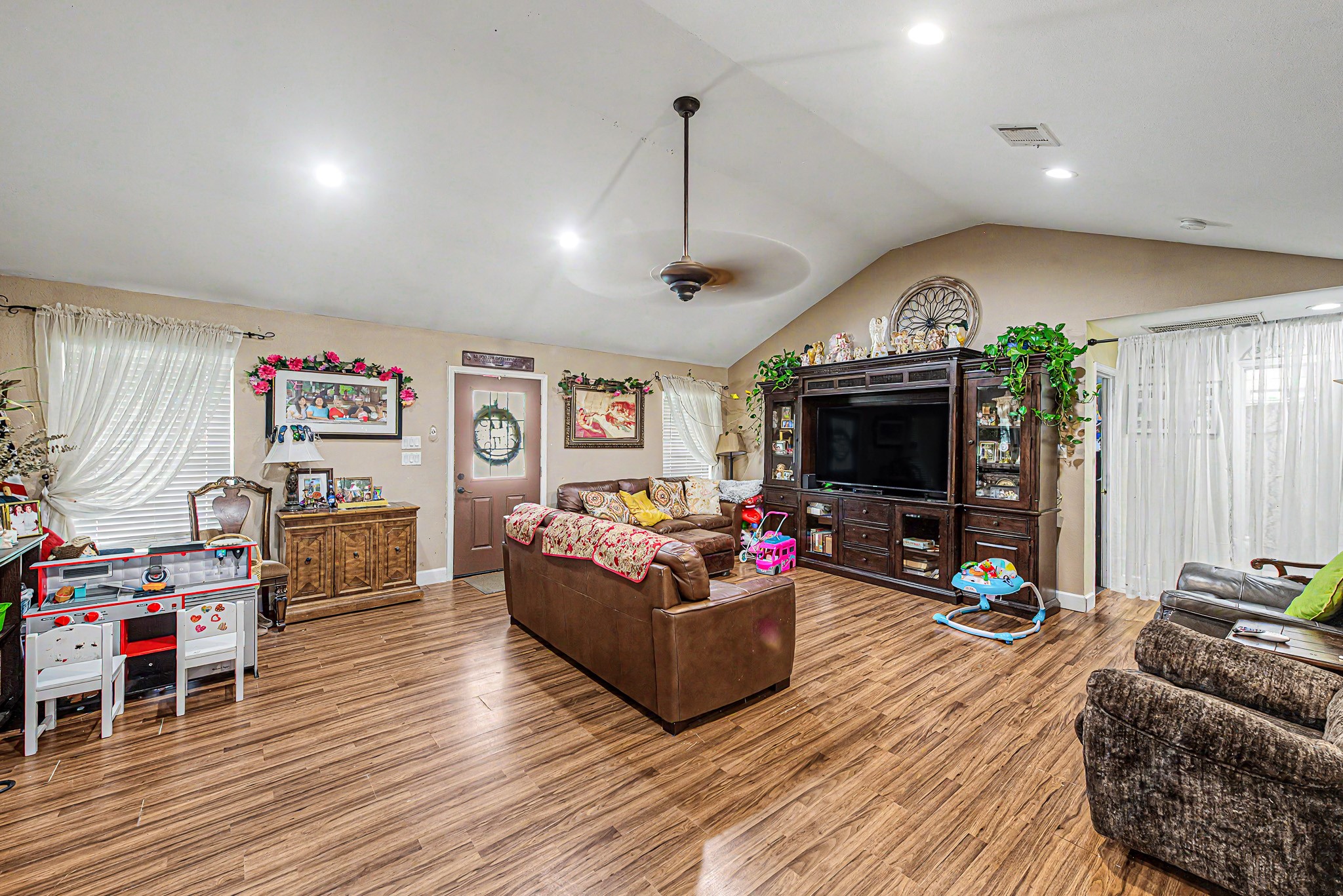 29867 Marti Road Katy, TX 77493 - Photo 36 of 36 a living room with furniture flat screen tv and a fireplace