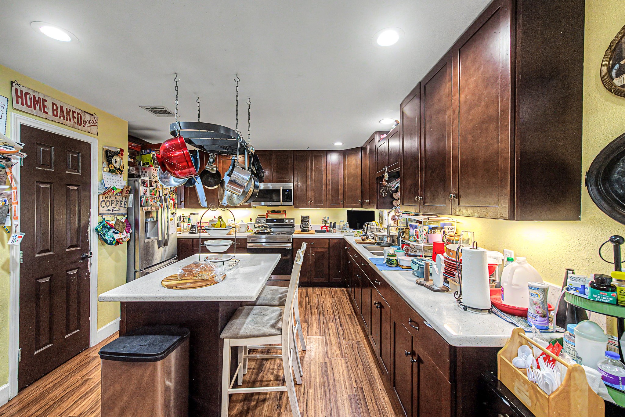 29867 Marti Road Katy, TX 77493 - Photo 18 of 36 a kitchen with a sink a microwave and cabinets