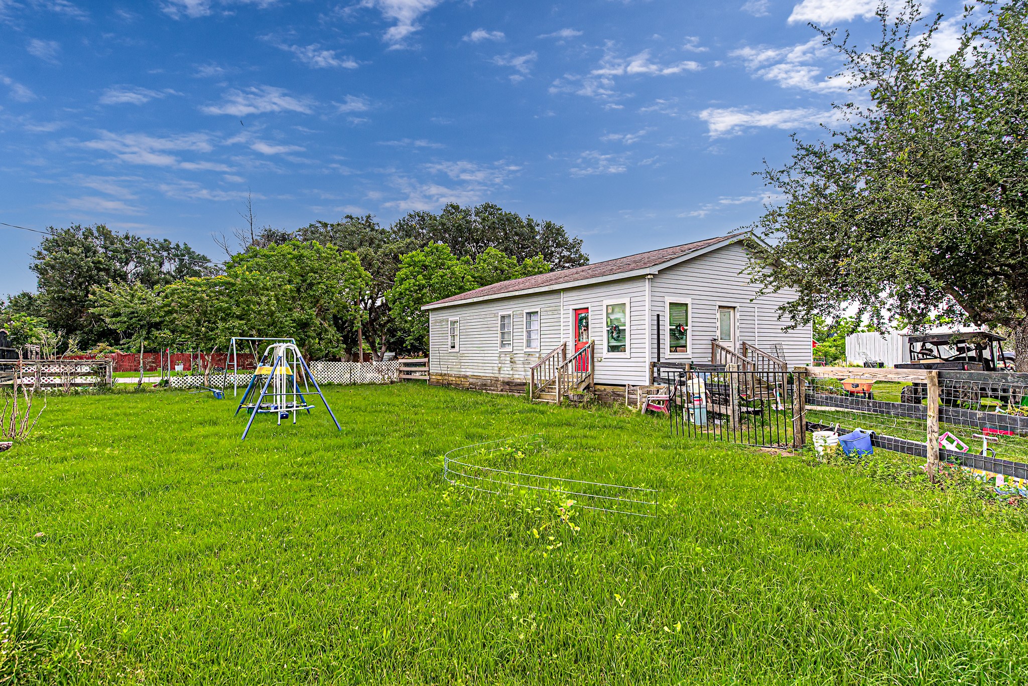 29867 Marti Road Katy, TX 77493 - Photo 26 of 36 a front view of a house with a garden and trees