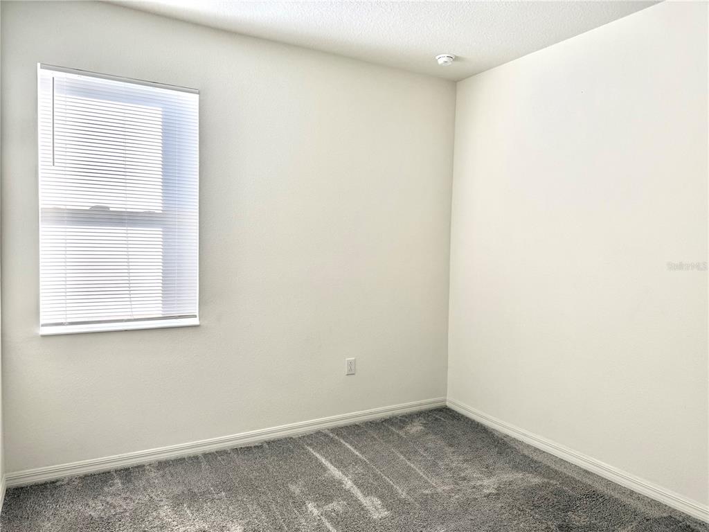 9023 Hooton Way Davenport, FL 33896 - Photo 18 of 25 an empty room with a window
