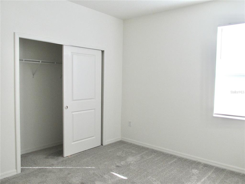 9023 Hooton Way Davenport, FL 33896 - Photo 23 of 25 an empty room with windows and closet