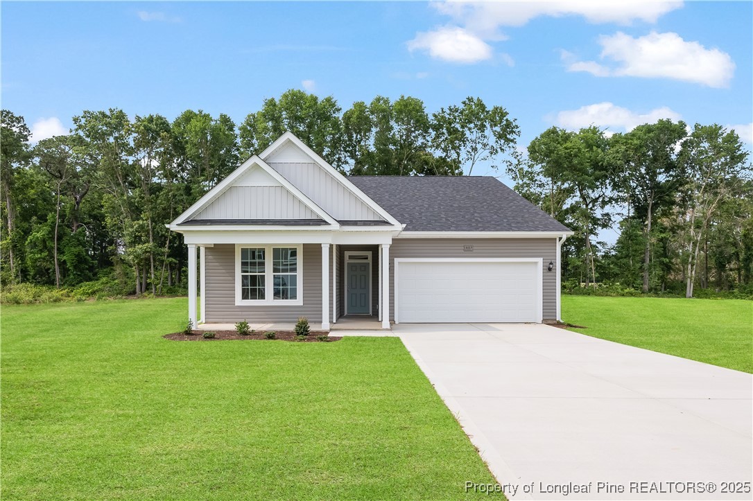 3117 Wolfpack Lane Eastover, NC 28312 - Photo 1 of 45 a front view of a house with a yard and trees