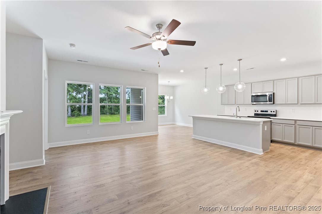 3117 Wolfpack Lane Eastover, NC 28312 - Photo 17 of 45 a view of kitchen with kitchen island wooden floor center island and stainless steel appliances