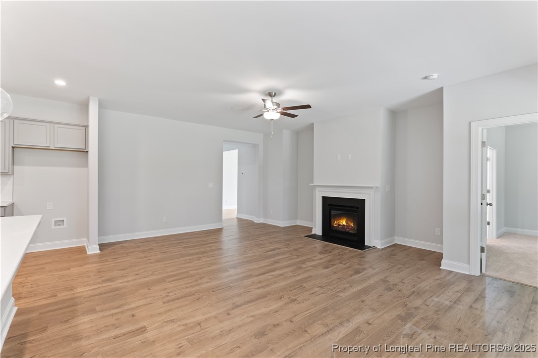 3117 Wolfpack Lane Eastover, NC 28312 - Photo 19 of 45 a view of a livingroom with a fireplace a fireplace and wooden floor
