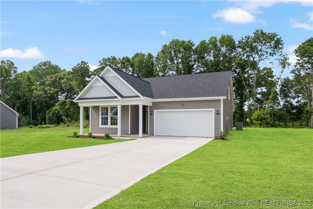 3117 Wolfpack Lane Eastover, NC 28312 - Photo 2 of 45 a front view of a house with a yard and garage