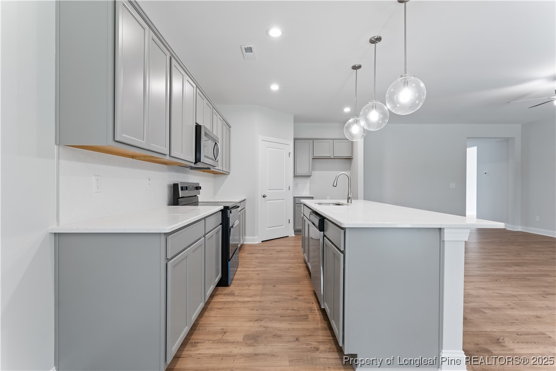 3117 Wolfpack Lane Eastover, NC 28312 - Photo 25 of 45 a kitchen with cabinets and wooden floor