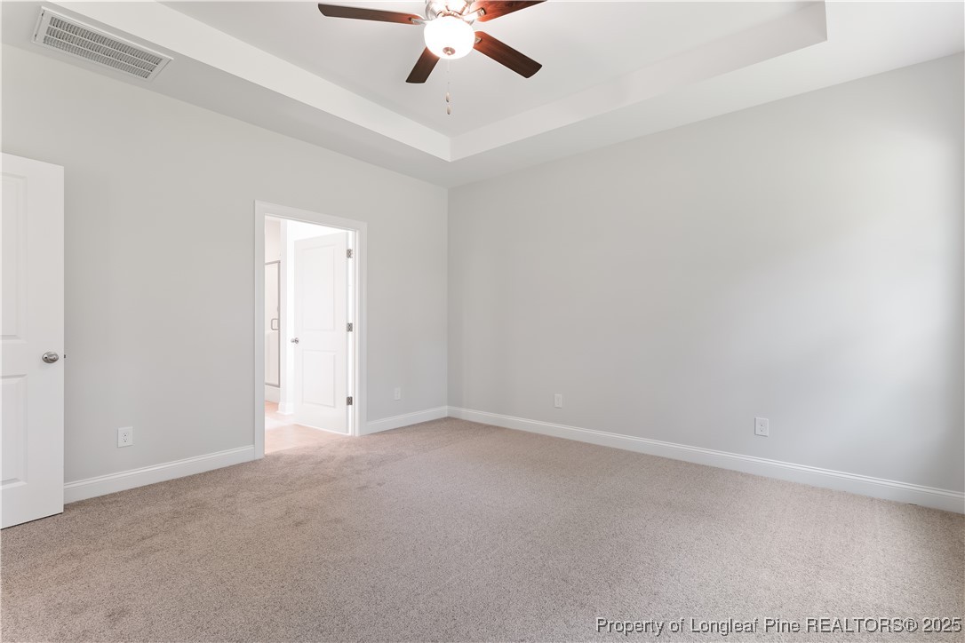 3117 Wolfpack Lane Eastover, NC 28312 - Photo 27 of 45 an empty room with a ceiling fan and window