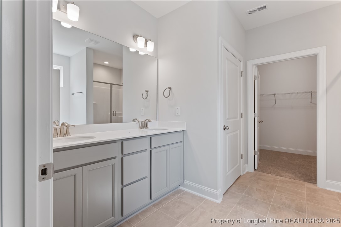 3117 Wolfpack Lane Eastover, NC 28312 - Photo 29 of 45 a bathroom with a double vanity sink and mirror