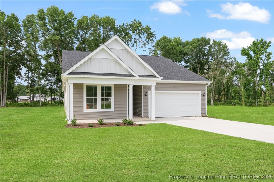 3117 Wolfpack Lane Eastover, NC 28312 - Photo 3 of 45 a front view of a house with a yard and trees