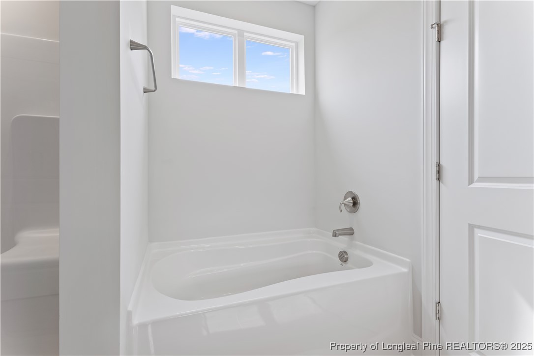 3117 Wolfpack Lane Eastover, NC 28312 - Photo 31 of 45 a white bath tub sitting next to a white sink