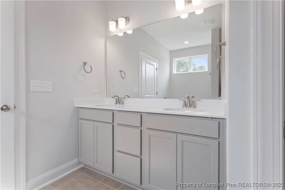 3117 Wolfpack Lane Eastover, NC 28312 - Photo 32 of 45 a bathroom with a sink vanity and mirror