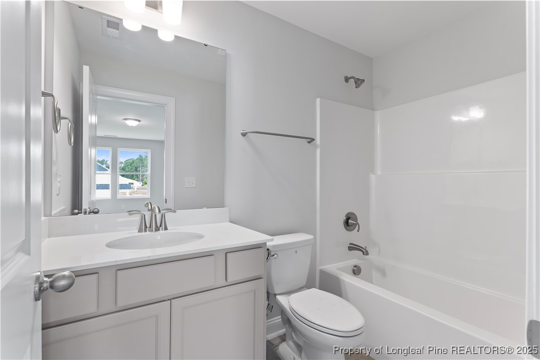 3117 Wolfpack Lane Eastover, NC 28312 - Photo 37 of 45 a bathroom with a sink a toilet and shower