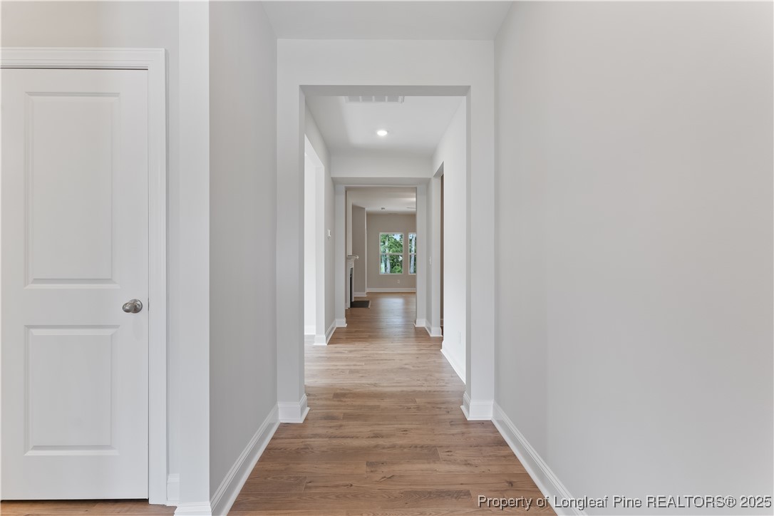 3117 Wolfpack Lane Eastover, NC 28312 - Photo 9 of 45 a view of a hallway with wooden floor