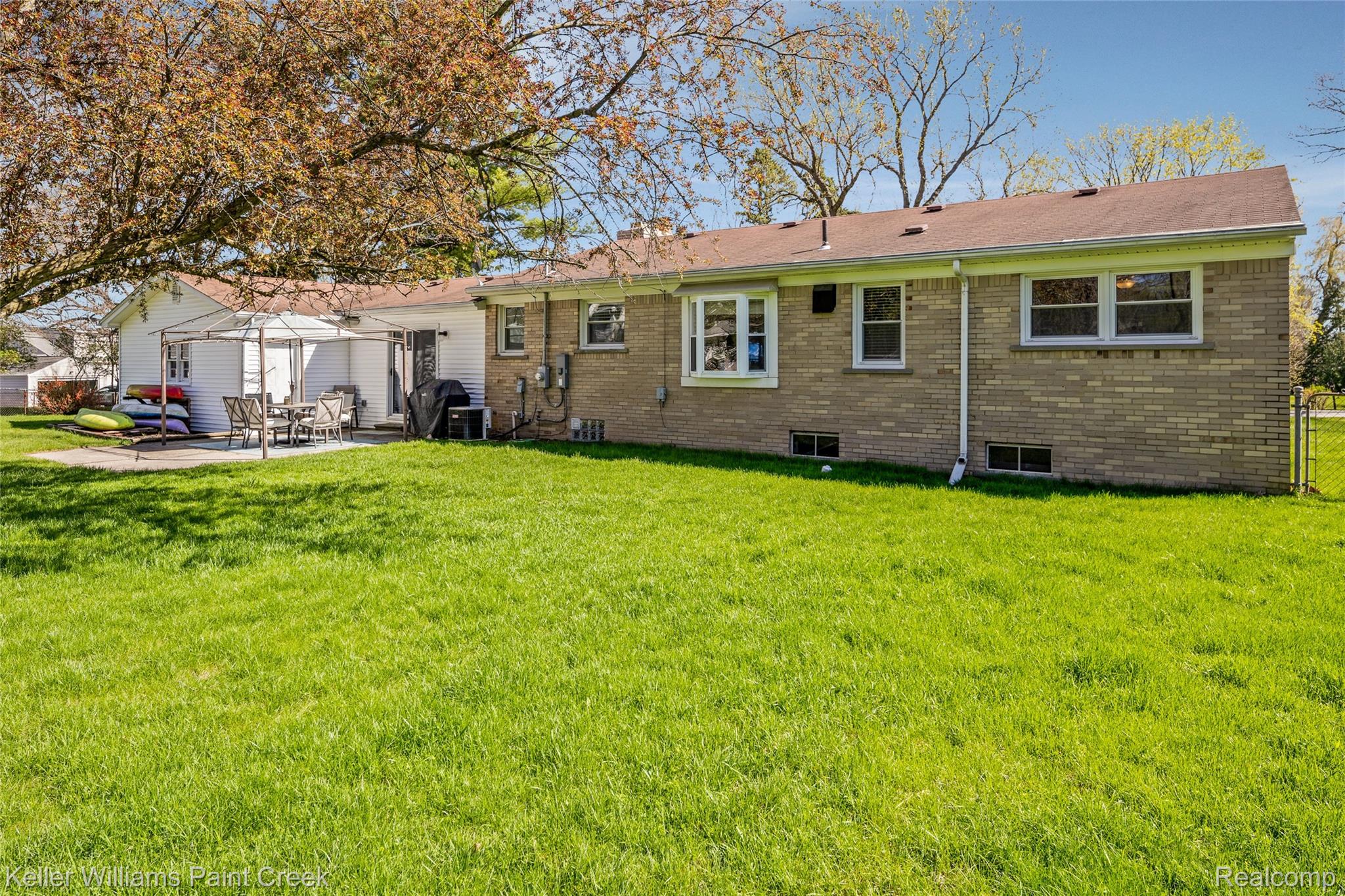 310 Elmhill Road Rochester, MI 48306 - Photo 32 of 37 Back of house with a patio, a lawn, brick siding, and a chimney