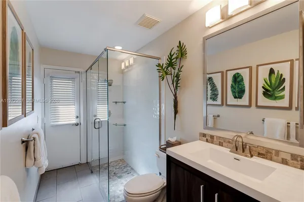 a bathroom with a sink toilet and shower
