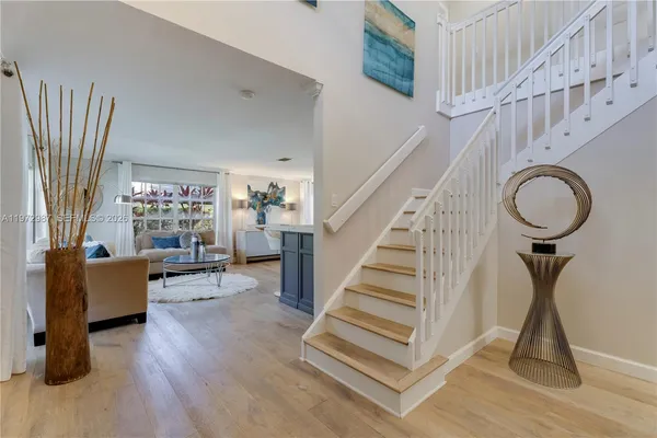 a view of entryway livingroom and hall with wooden floor