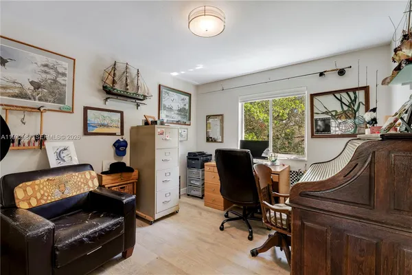 a view of a workspace with furniture and a window