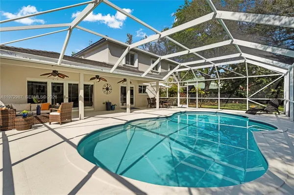 a view of a patio with table and chairs under an umbrella