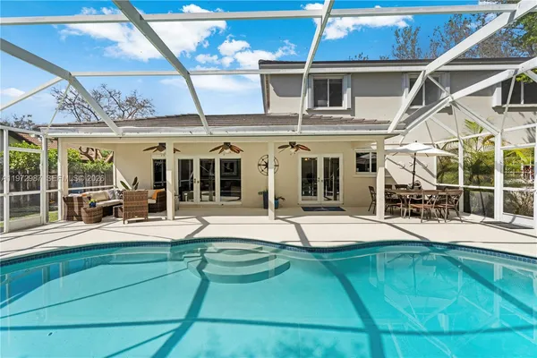 a view of a backyard with swimming pool
