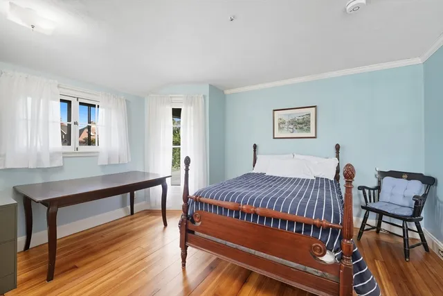 a bed room with a bed and a window