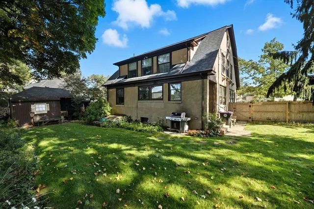 a backyard of a house with table and chairs