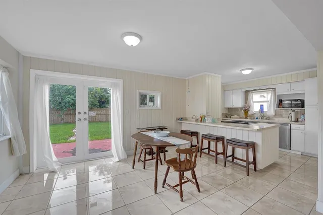 a view of a dining room with furniture and a window