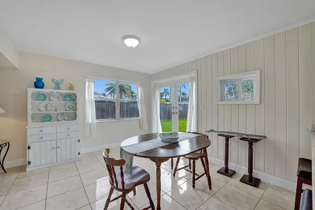 a view of a dining room with furniture and window