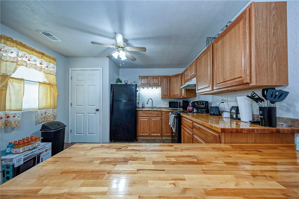 249 Washington Road, Unit 3 Waynesburg, PA 15370 - Photo 3 of 10 a kitchen with stainless steel appliances granite countertop a refrigerator a sink dishwasher a stove and white countertops with wooden floor
