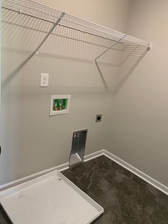 a view of a room with wooden floor and bench